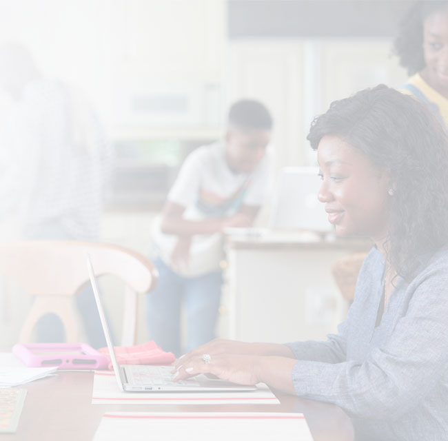 A UMGC student, who is pursuing an MBA, is typing on a laptop. 