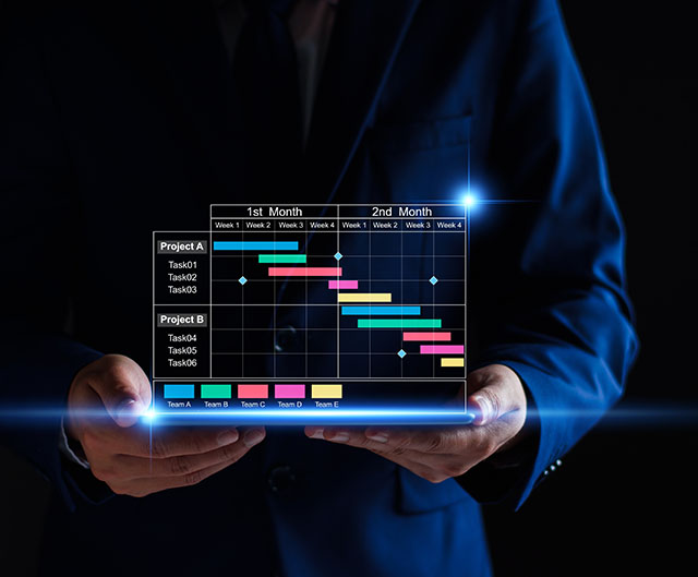 Project manager working on tablet and updating tasks and milestones progress planning with Gantt chart scheduling interface for company on virtual screen. Business Project Management System.
