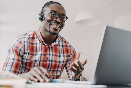 Friendly manager of client support service. African american man in headset receives calls. Online shop assistant is working from home. Teacher has remote lesson. Student gets distant education.