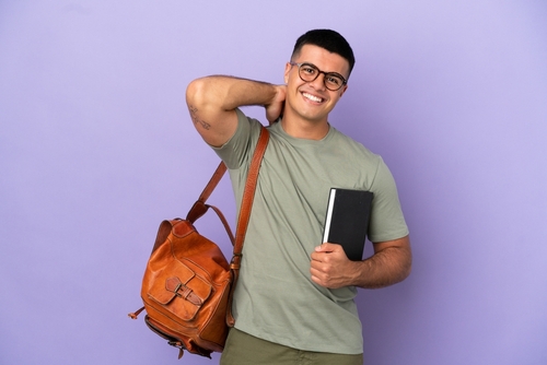 Handsome student man over isolated background laughing