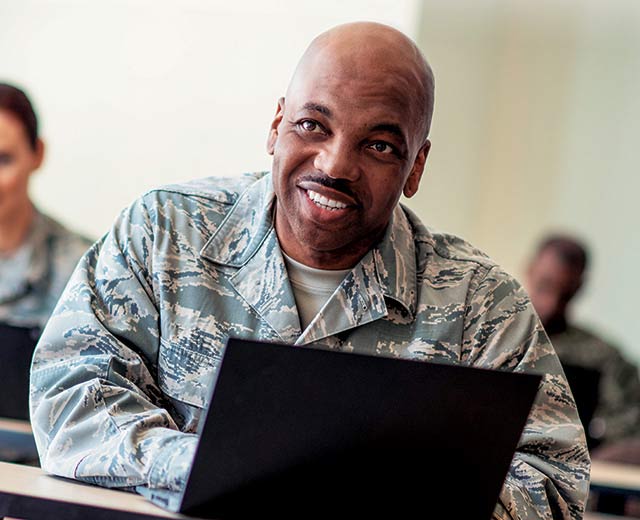 A person in uniform smiling.