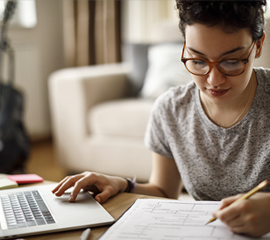 A woman sitting down at her laptop.